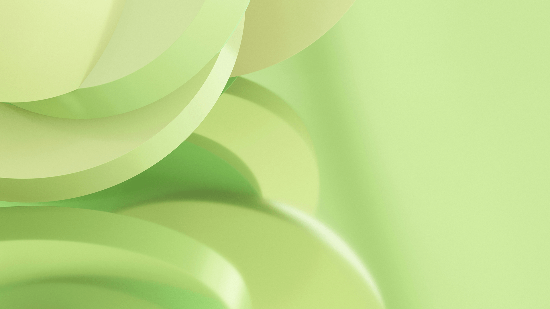 Abstract close-up of overlapping smooth green circular shapes with soft lighting.