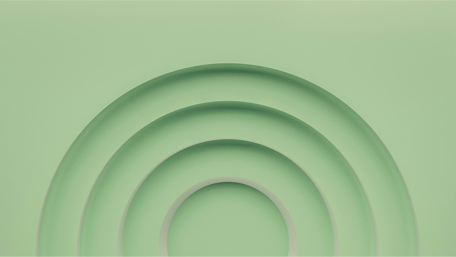 Three nested semi-circular cuts or arches in a green surface, creating a layered shadow effect.