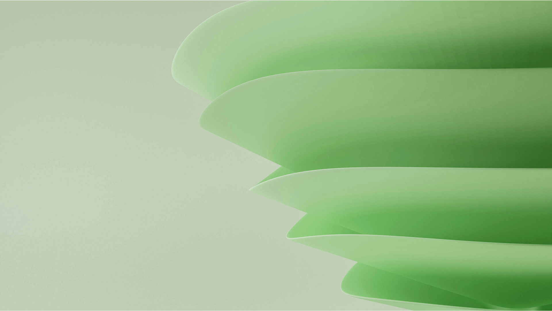 Abstract close-up of layered green translucent shapes on a light green background.